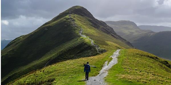 Person walking over mountains in the Lake District